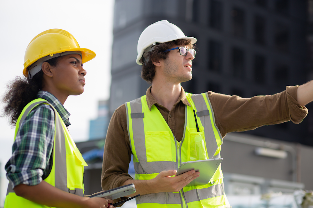 Field service workers in safety vests looking into the distance