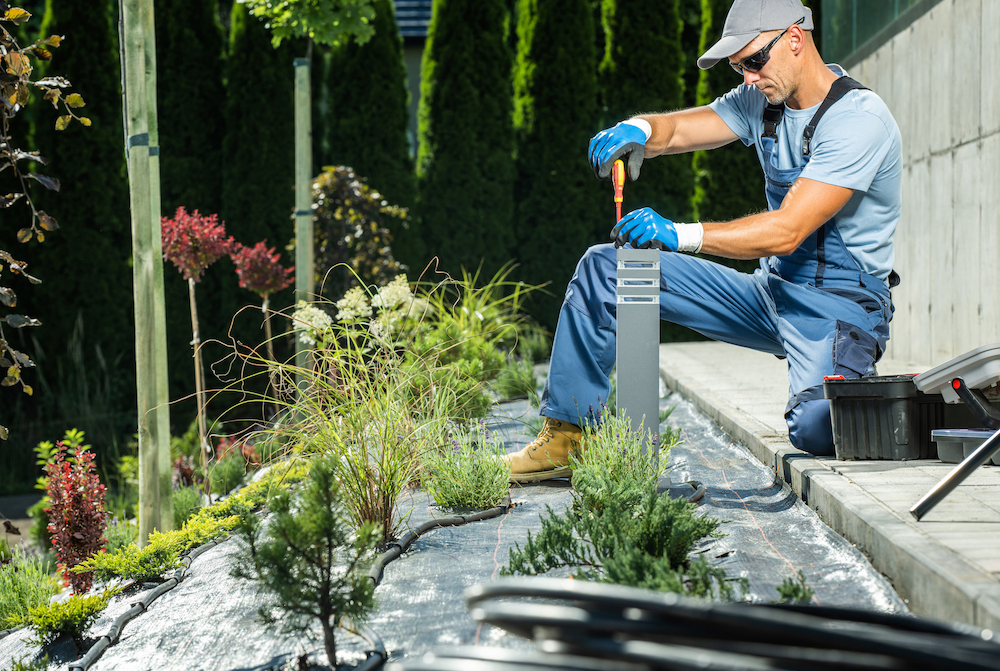 Worker performing landscape maintenance