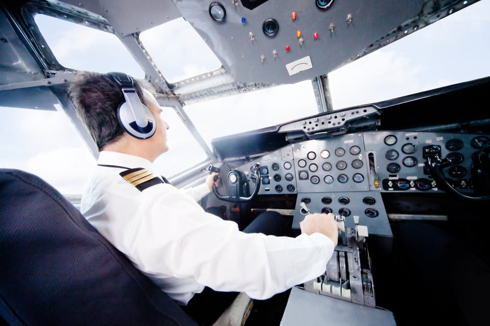 Pilot in an airplane cabin flying a plane