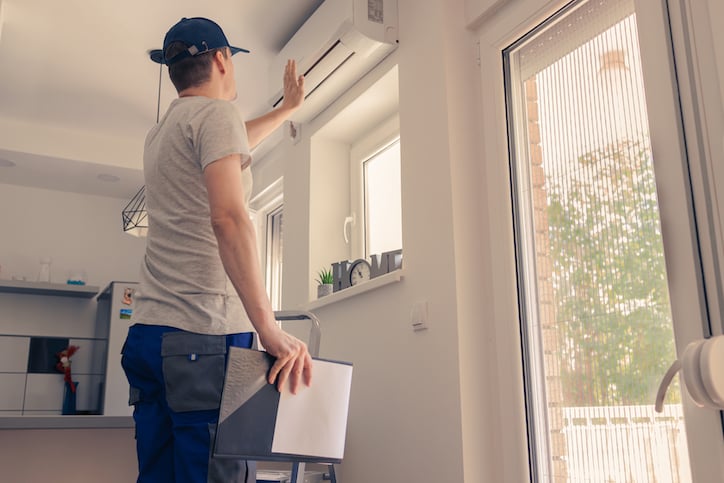 maintenance technician inspecting a residence through work order assignment in his property management work order software 