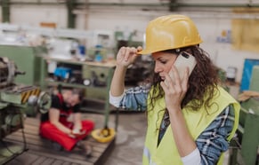 maintenance worker on phone talking about the halt in the production process due to abnormal idle time