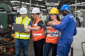 workers on site looking at preventative maintenance tasks via cmms